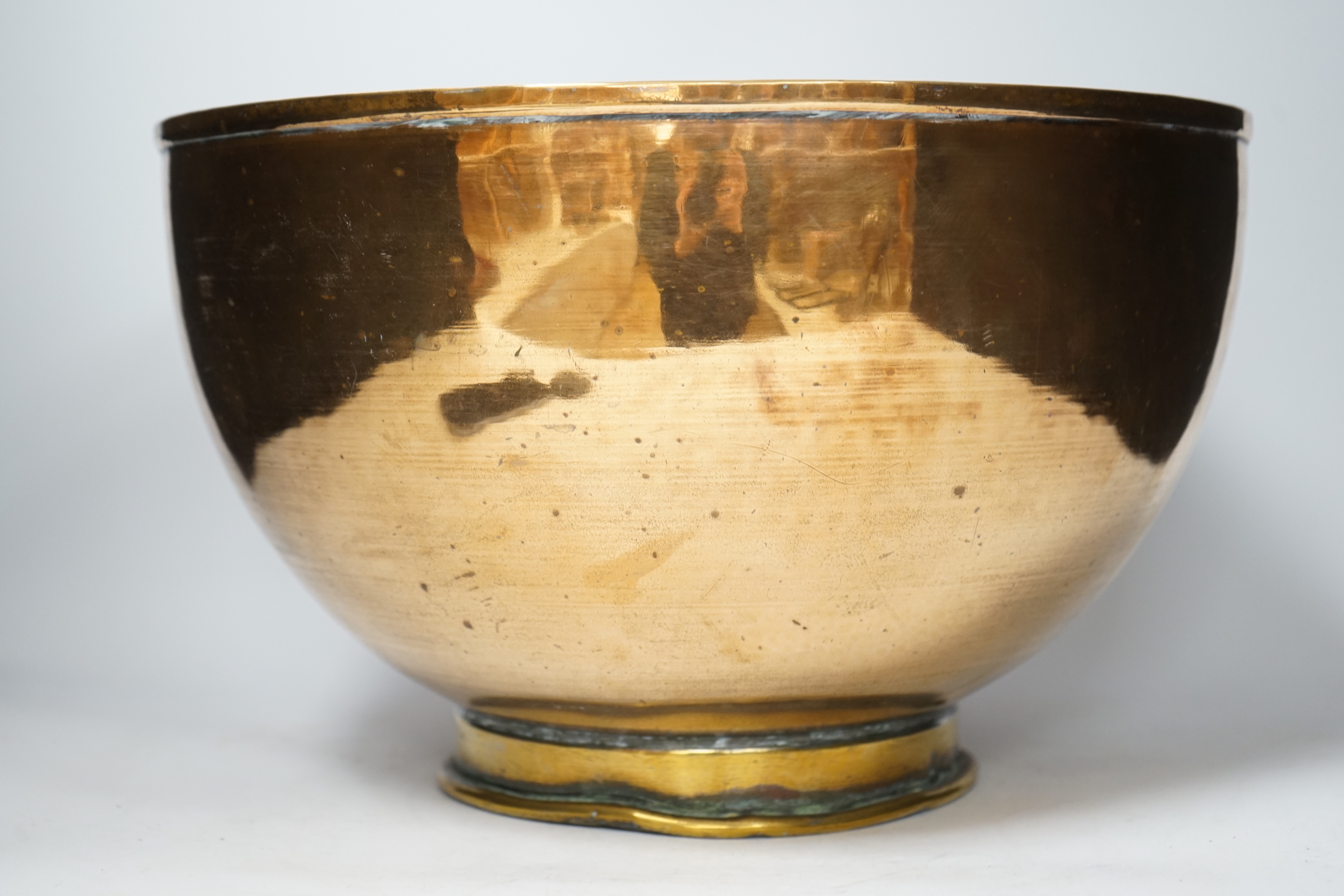 A large copper bowl with brass foot rim, 39cm diameter